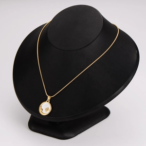 French style sun necklace with white face silhouette on a snake chain shown on a bust