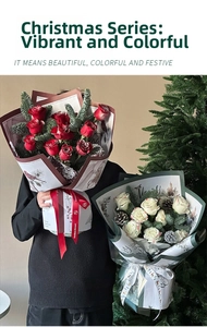 Detailed view of Christmas bouquet packaging with red roses, pine branches and festive ribbons