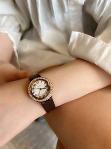 Close-up of elegant Scottie ladies' watch with rose gold diamond bezel and blue hands