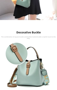 Detail view of the green leather bucket bag with brown strap buckle and wide patterned shoulder strap