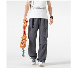 Detail of cargo pants showing side zipper pockets, adjustable waistband and drawcord cuffs