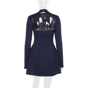 Detail of navy blue long sleeve dress showing a large circular open back on a mannequin