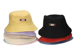 Close-up of multicolored cotton canvas sun hats with stitched brims and leather labels