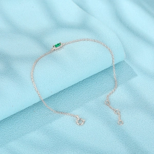 Detailed macro view of S925 silver bracelet with marquise green zircon and link chain
