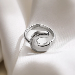 Minimalist silver letter C open adjustable ring on white silk background