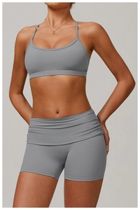 Detail view of grey yoga set with high waist scrunch shorts and thin strap sports bra