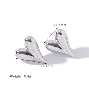 Macro shot of liquid silver heart studs with high-mirror polish and irregular shape