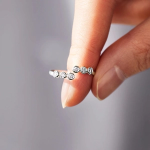Macro detail of S925 sterling silver ring featuring zircon stones and adjustable open band