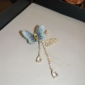 Elegant zircon butterfly brooch with blue tassel and gold metal plating for women
