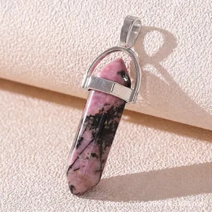 Macro shot of pink and black natural stone hexagonal point pendant with silver clasp