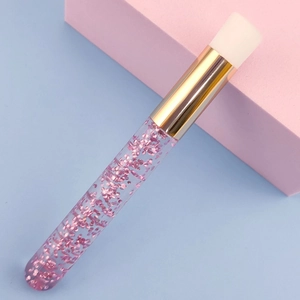 Eyelash cleaning brush with pink glitter handle and soft white bristles for facial care