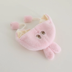Detail of pink plush baby winter hat featuring soft faux fur texture and cute ears