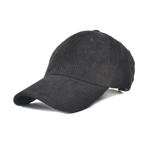 Detail view of the black corduroy fabric texture and curved brim of the baseball cap