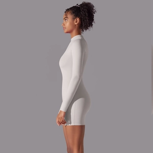 Side view of long-sleeved light gray yoga bodysuit showing slim fit and elastic fabric