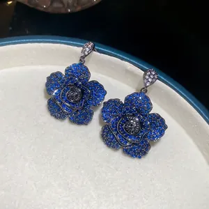 Blue zircon camellia flower drop earrings with silver needles and intricate crystal pave