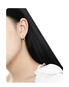 Side view of model wearing minimalist silver micro-pave cubic zirconia hoop earrings