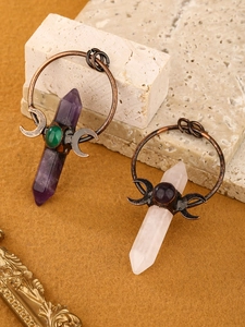 Detail view of amethyst and crystal hexagonal pendants with bronze crescent moon frames