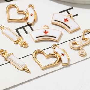 DIY medical charm set featuring gold stethoscope and syringe pendants on card background