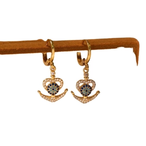 Golden anchor and heart earrings with blue zircons for women on a display stand