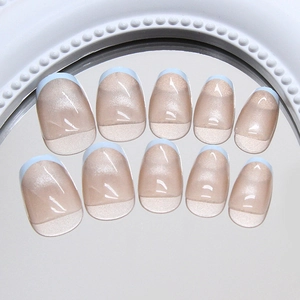 French tip cat-eye press-on nails in baby blue and nude pink with shimmer effect