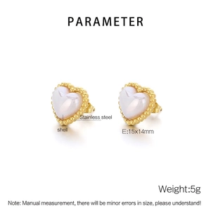 Detailed view of heart-shaped shell earrings with gold beaded stainless steel borders