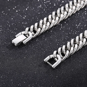 Detailed macro of a polished silver curb chain with a secure stainless steel fold-over clasp