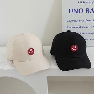 Classic kids baseball cap with smiley face patch in cream white and black colors