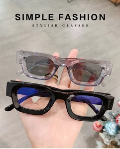 Detail view of square frame sunglasses showing grey and black acetate finishes and CE markings