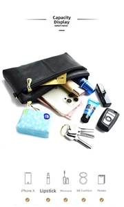 Internal view of black pebble leather bag showing storage for phone and makeup