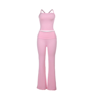Detail of pink two-piece yoga set featuring cross-back camisole and flared leggings