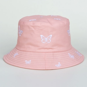 Close-up of intricate white butterfly embroidery on a pink cotton bucket sun hat