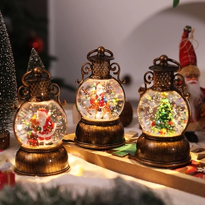 Close-up of vintage Christmas lanterns with Santa Claus and LED glowing glitter globes