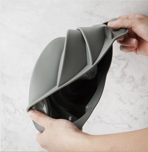 Detailed view showing the flexibility of a heat-resistant grey silicone cake mold