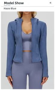 Detailed view of haze blue fleece-lined hooded jacket with matching sports bra and leggings