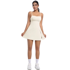 Cream-colored athletic dress featuring slim straps and a stylish side slit design
