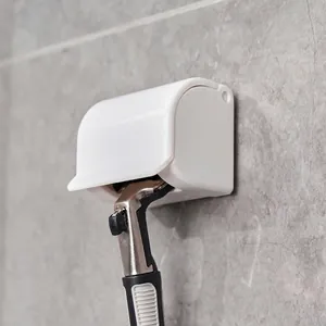 Wall-mounted white manual razor holder with a dust-proof cover for bathroom storage