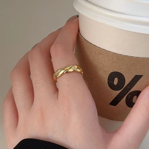 Elegant 925 sterling silver gold-plated twisted rope ring shown on hand with coffee