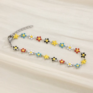 Macro detail of silver daisy bracelet with colorful enamel petals and lobster clasp