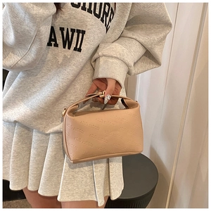 Detail of beige leather crossbody bag with rich rabbit embossed pattern and gold hardware