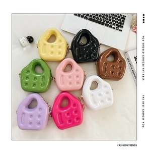 Flat lay of colorful PVC jelly mini bags with relief dot texture and metal chain straps