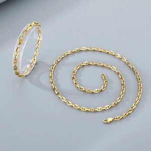 Macro view of gold coffee bean link necklace and bracelet set in polished finish