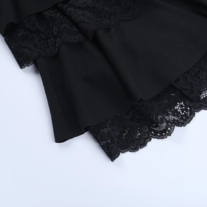 Detailed macro view of delicate black lace trim on minimalist mini dress fabric