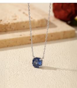 Macro shot of S925 sterling silver necklace with royal blue rose cut sapphire pendant