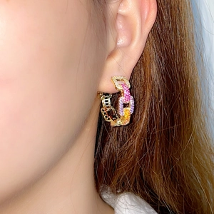 French style gold earrings with rainbow zircons and colored stones on chain link hoops