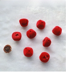 Close-up of 2.5cm red flocked Christmas bells with cross opening for DIY wreaths