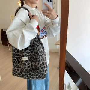 Detailed texture of black and grey leopard print faux fur on a large capacity tote bag
