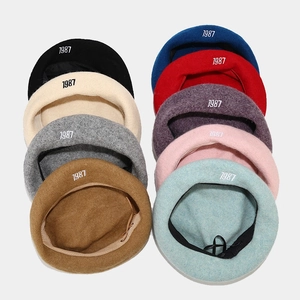 Detail of 1987 embroidered wool beret showing nine color options and inner drawstring