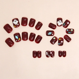 Deep wine red press-on nails with shiny glitter stars and sparkling diamond accents