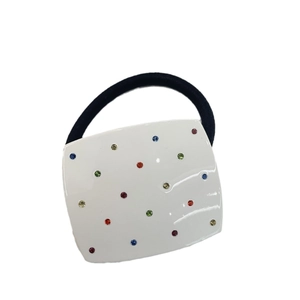 White square resin hair tie with colorful crystals and black elastic cord on white background