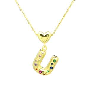Detailed shot of a gold heart charm and letter U pendant set with colorful zirconia